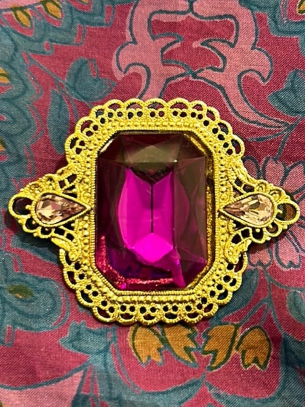 Brass brooch with purple gem